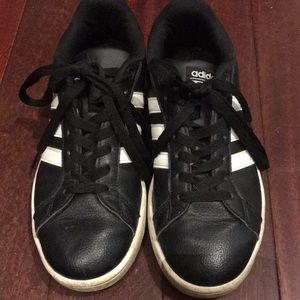 Black adidas with white stripes